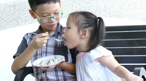 Siblings eating fruit together Stock Footage 68223507