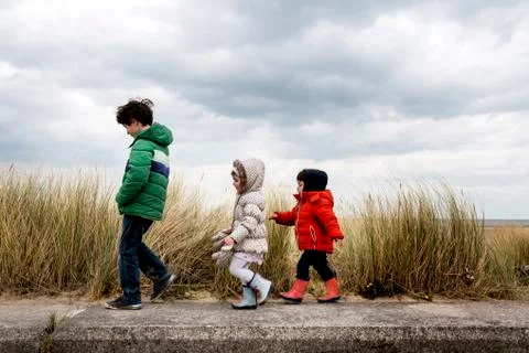Siblings exploring beach Stock Photos