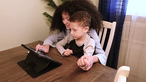 Siblings fighting to use the tablet Stock Footage 168707512