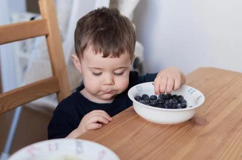 Siblings fooling around at the breakfast table Stock Photos