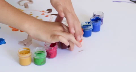 Siblings hands take gouache to paint picture for parents Stockbeeldmateriaal 228558085