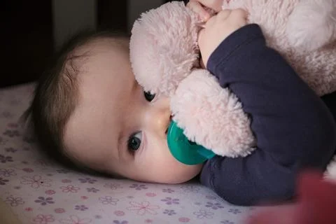 Siblings hugging on the bed Stock Photos