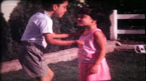 Siblings kissing for the camera 1950s vintage film home movie 1066 Stock Footage 37582856