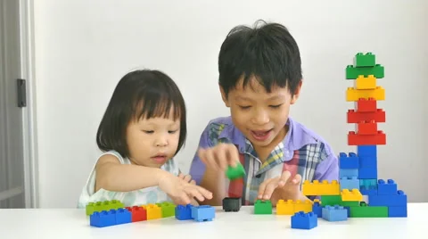 Siblings playing blocks together Stock Footage 55698760
