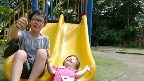 Siblings playing in playground Stock Footage 84967495