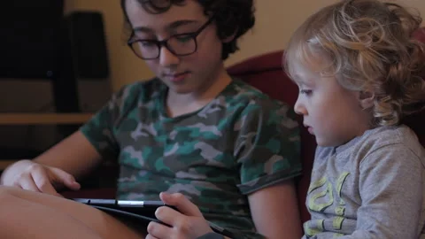 Siblings playing together on tablet. Stock Footage 148098710