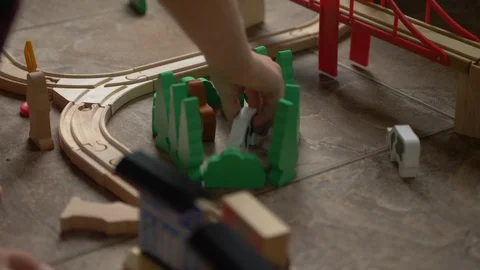 Siblings playing with a wood train Stock Footage 129523461