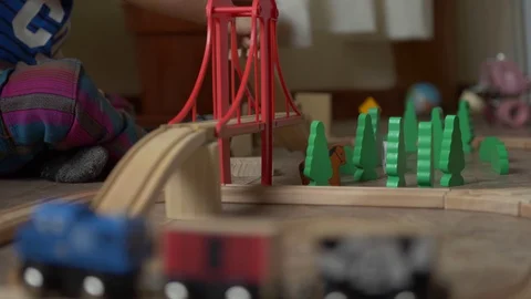 Siblings playing with a wood train Stock Footage 129523891