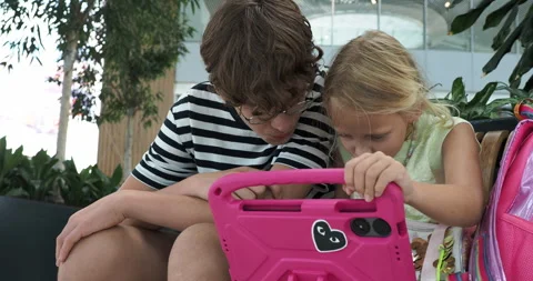 Siblings Sharing a Tablet Computer Stock Footage 330059406