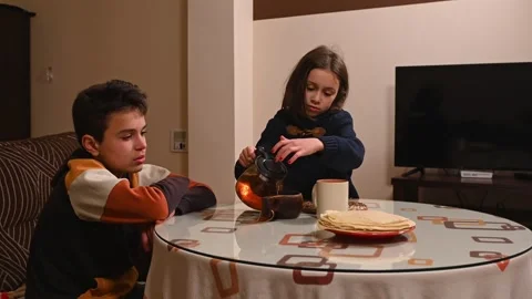 Siblings sharing tea around the table Stock Footage 297518054
