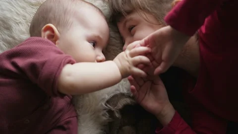 Siblings two sisters are playing a girl and a baby happy smiling Stock-Footage 146965097