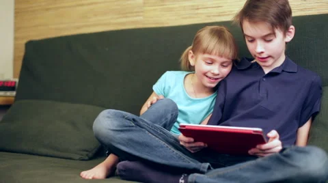 Siblings using a tablet computer panning Stock Footage 48718746