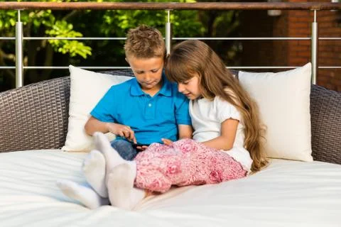 Siblings using tablet Stock Photos