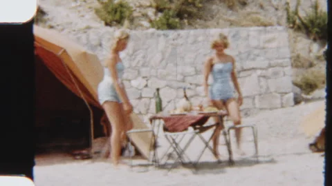 Siblings Walk Toward Outdoor Table Beside Tent At Beach Camp Stock Footage 322133627