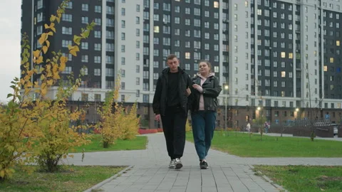 Siblings Walking Along City Path in Autumn Wearing Jackets Stock-Footage 305795853