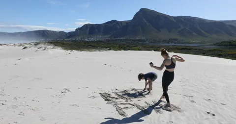 Siblings walking on beach, Walker Bay Nature Reserve, Western Cape, South Africa Video stock 202920478
