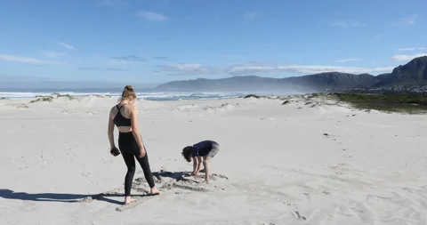 Siblings walking on beach, Walker Bay Nature Reserve, Western Cape, South Africa Video stock 202923103