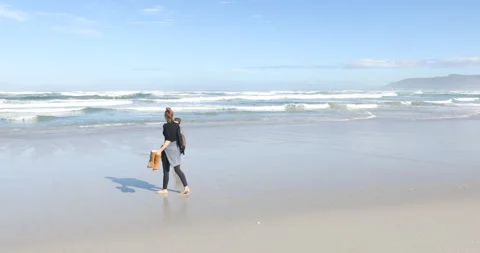 Siblings walking on beach, Walker Bay Nature Reserve, Western Cape, South Africa Stock Footage 202961991