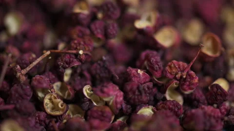 Sichuan peppercorns falling down close up macro slow motion Stock Footage 158040978