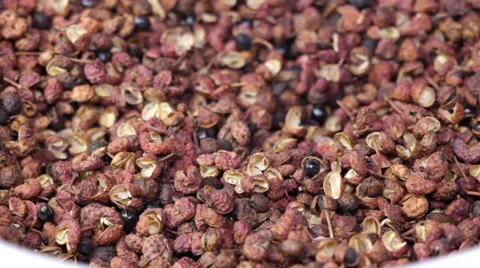Sichuan peppercorns rotating surface with  peppercorns falling Stock Footage 62372025