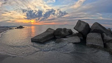 Sicilian sunset between clouds and rocks Stock Photos