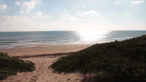 Sicily italy beach sand with low sun shining bright above and on water ocean Stock Footage 252152276