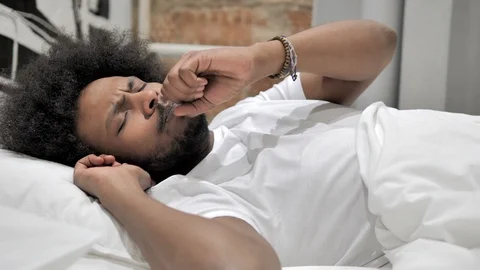 Sick African Man Coughing while Sleeping in Bed, Cough Stock Footage 104330888