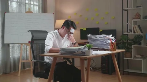 Sick Asian Man Having Flu While Working Hard With Documents At The Office Stock Footage 196116868