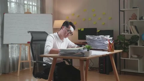 Sick Asian Man Working Hard With Documents At The Office Stock Footage 196116213