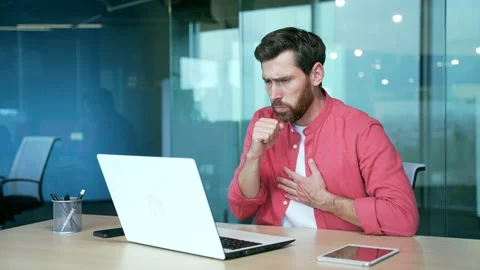 Sick bearded business man freelancer typing on laptop cough a lot while sitting  Stock Footage 234145703