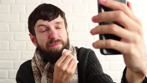 Sick bearded man using smartphone video call conversation close up Stock Footage 150529935