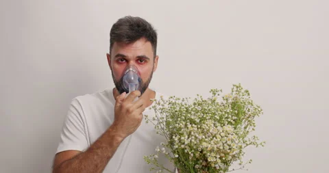 Sick bearded man wears nebulizer mask suffers from bronchial asthma has Stock Footage 157939828