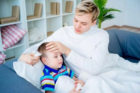 Sick boy in bed Stock Photos