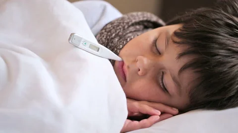 Sick boy with digital thermometer Stock Footage 46317180