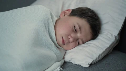 Sick boy sleeping on the couch Stock Footage 241508119