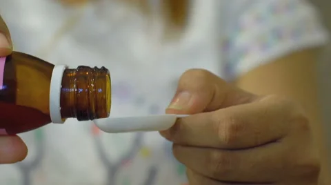 Sick boy taking cough syrup Stock Footage 62153848