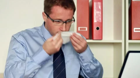 Sick businessman blowing his nose into tissue in the office, steadicam shot HD Stock Footage