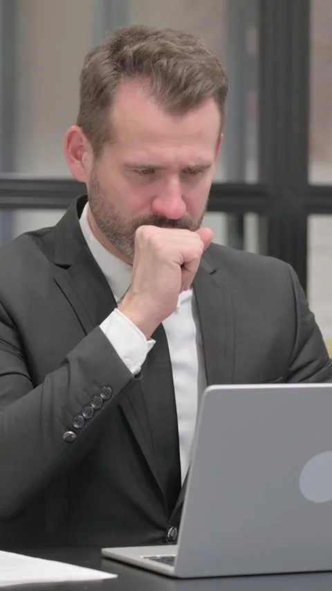 Sick Businessman Coughing while Working on Laptop, vertical video Stock Footage 324795724