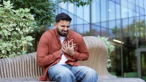 Sick businessman suffering from heart attack, chest tension sitting on bench  Stock Footage 304596007