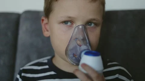 Sick child boy makes inhalation using nebulizer Stock Footage 253658557