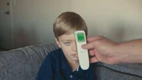 Sick child having temperature measured with digital thermometer Stock-Footage 346969651