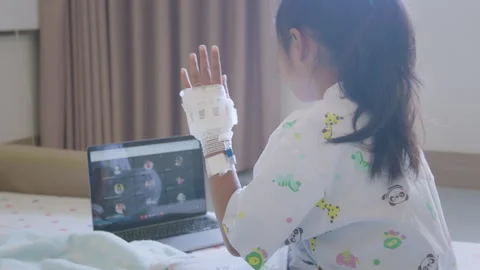 Sick child learning online class with teacher and friend at hospital Stock Footage 287896651