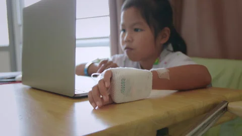 Sick child learning online class with teacher and friend at hospital Stock Footage 287897598