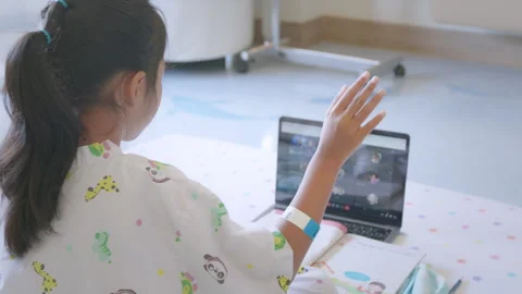Sick child learning online class with teacher and friend at hospital Stock Footage 289345792