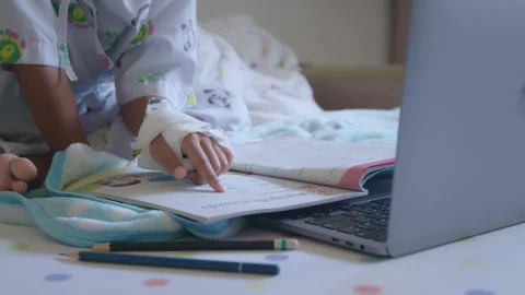 Sick child learning online class with teacher and friend at hospital Stock Footage 289346229