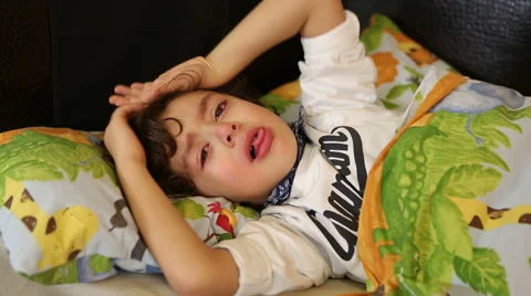 Sick child lying in bed and coughing Stock Footage 44367351