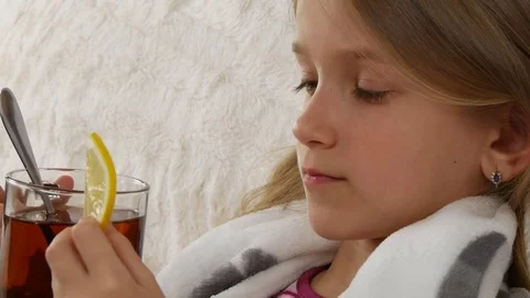 Sick Child Portrait Drinking Lemon Tea, Sad Ill Girl Face in Bed, Sofa Stock Footage