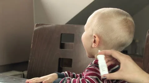 Sick child refusing nasal medicine Stock Footage 11829997