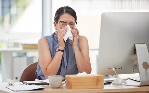Sick, computer and blowing nose with woman in office for virus, illness and Stock Photos