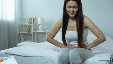 Sick female feeling sharp pain in abdomen, miscarriage danger, induced abortion Stock Footage 91563659